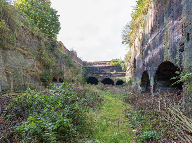 View of the overgrown cutting and brick arches of the Edge Hill Engine Station structures.