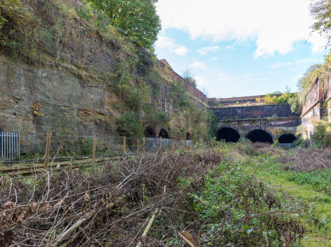 Long view of the cutting showing multiple arches and retaining walls.