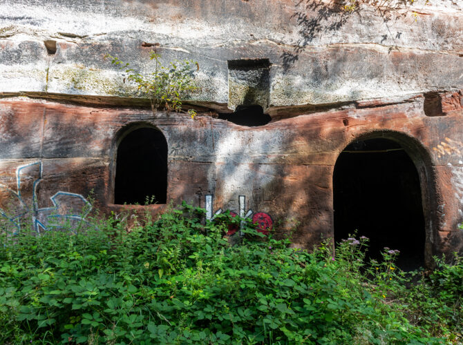 Detail of the sandstone wall showing arched recesses and openings