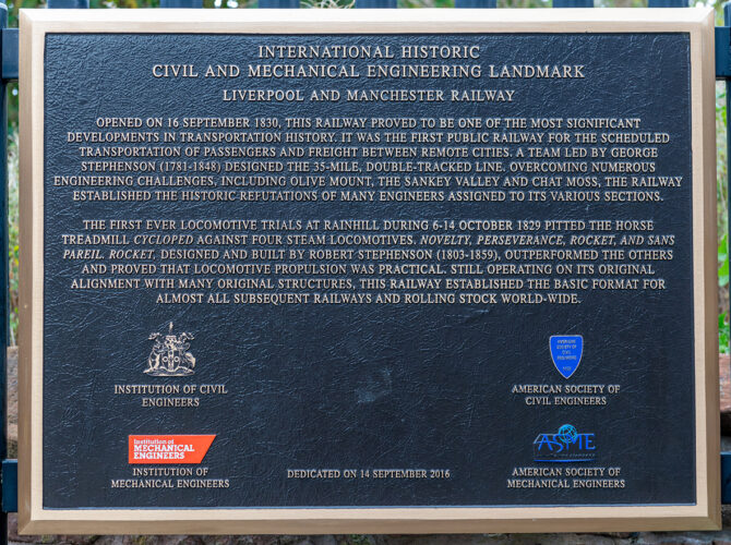 Metal plaque describing the significance of the Liverpool and Manchester Railway and the Rainhill Trials.
