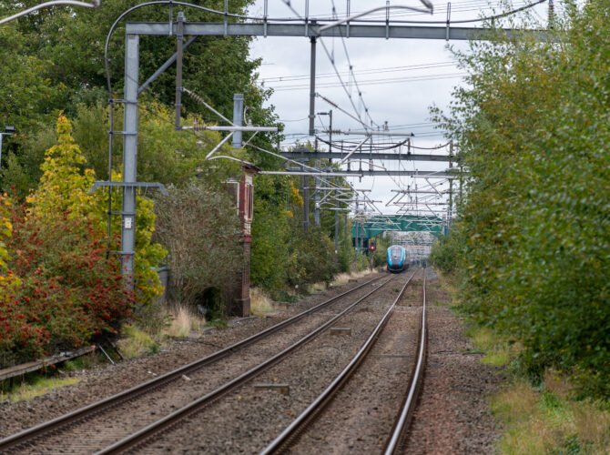 Train on a long straight section of railway where the Rainhill Trials were held in 1829.