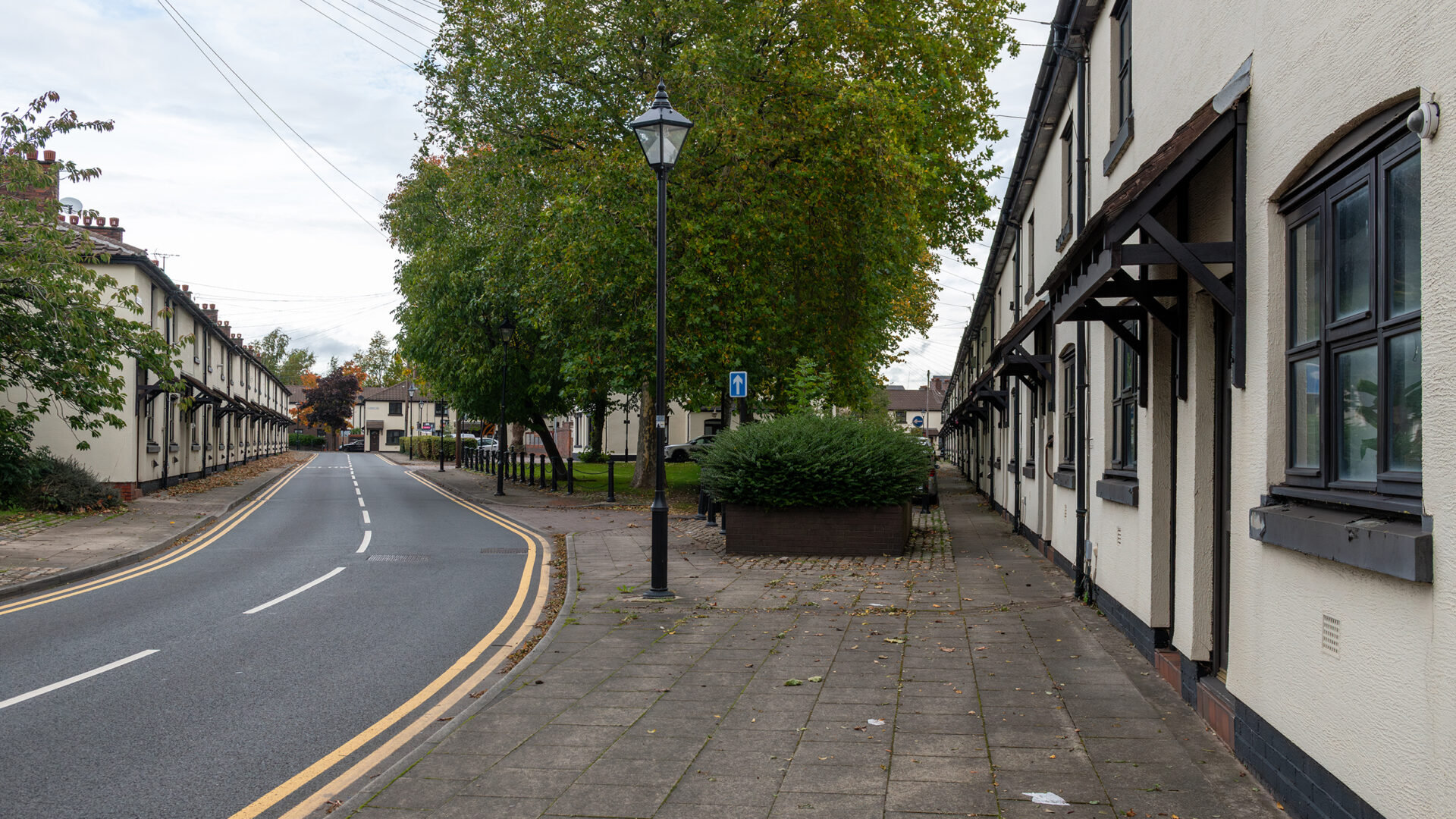 View across the village green with rows of workers’ cottages on either side.