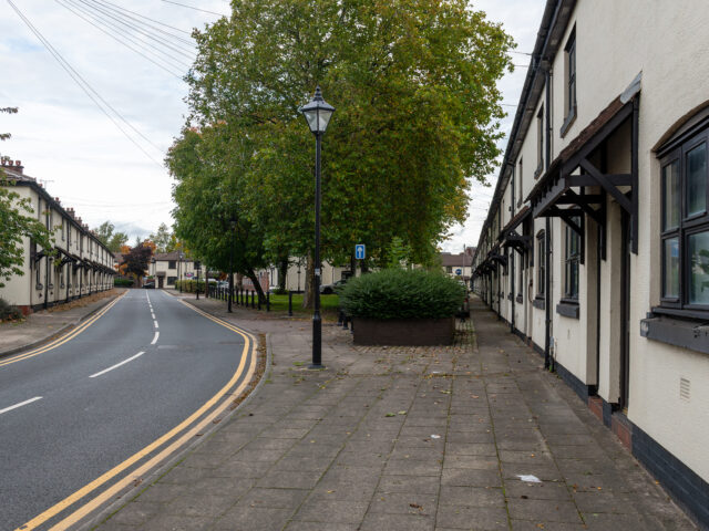 View across the village green with rows of workers’ cottages on either side.