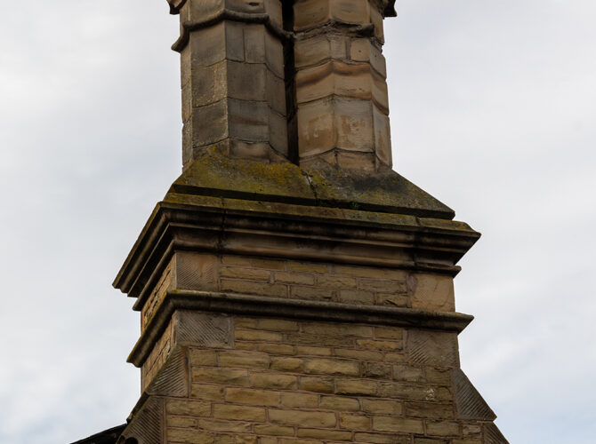 One of the distinctive Victorian chimneys rising above the brick and stone roof of Earlestown Station.