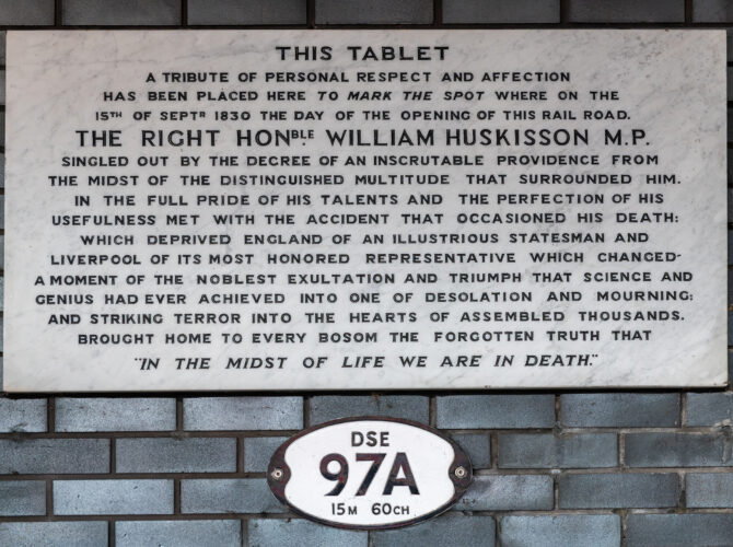 A close view of the marble memorial inscription commemorating William Huskisson and marking the location of the accident during the opening of the Liverpool and Manchester Railway in 1830.