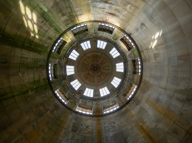 Looking up inside the monument reveals a domed ceiling with a ring of small windows.