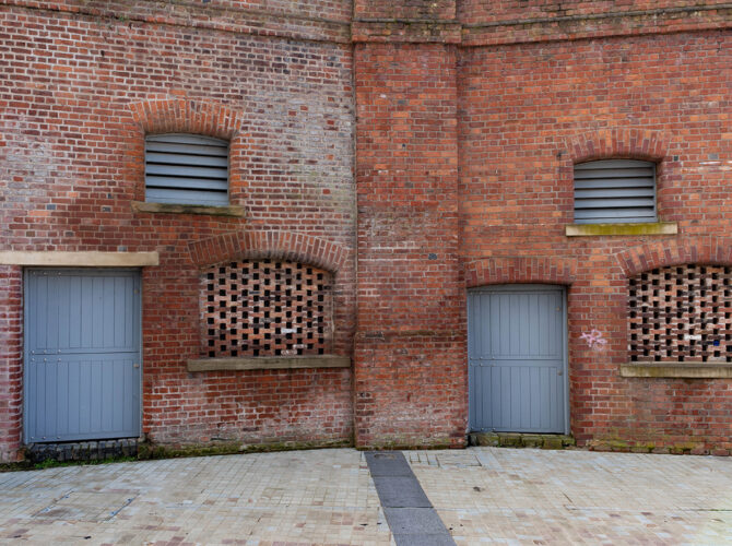 Repeating arches and infilled openings showing how the station structure has been reused over time.
