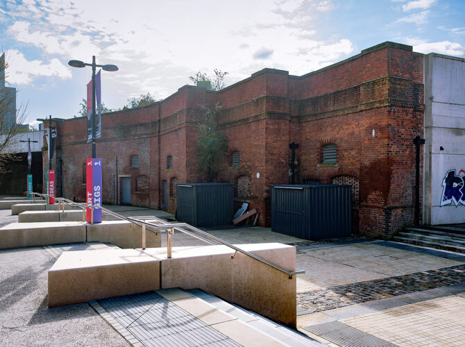 Surviving viaduct wall leading to Lower Byrom Street Warehouse set within a redeveloped riverside area.