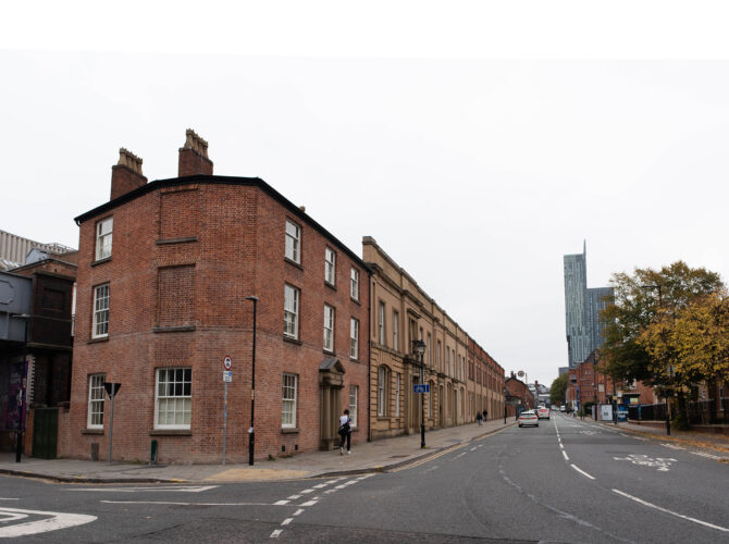 Wide view of the continuous row of station structures, including the Station Master’s House, forming part of the early railway complex.