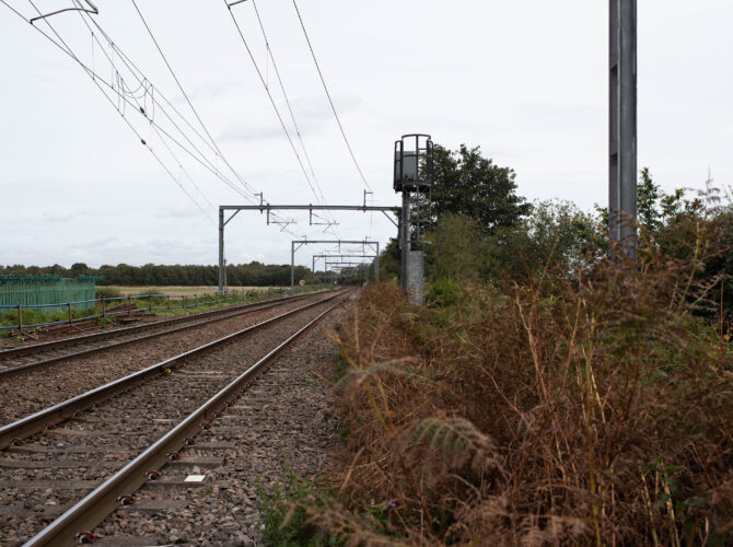 Railway tracks across Chat Moss with a tall signal platform beside the line