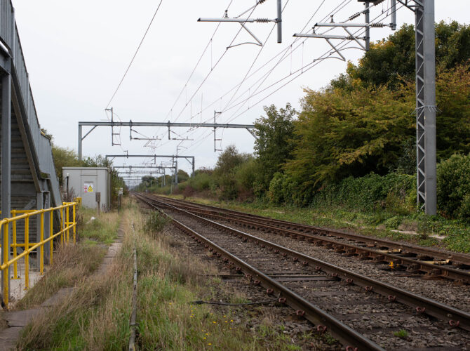 Electrified railway line with signalling equipment and trackside building on Chat Moss.