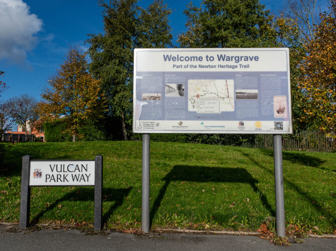 An information board for the Newton Heritage Trail stands beside a Vulcan Park Way street sign near the former site of the Vulcan Foundry