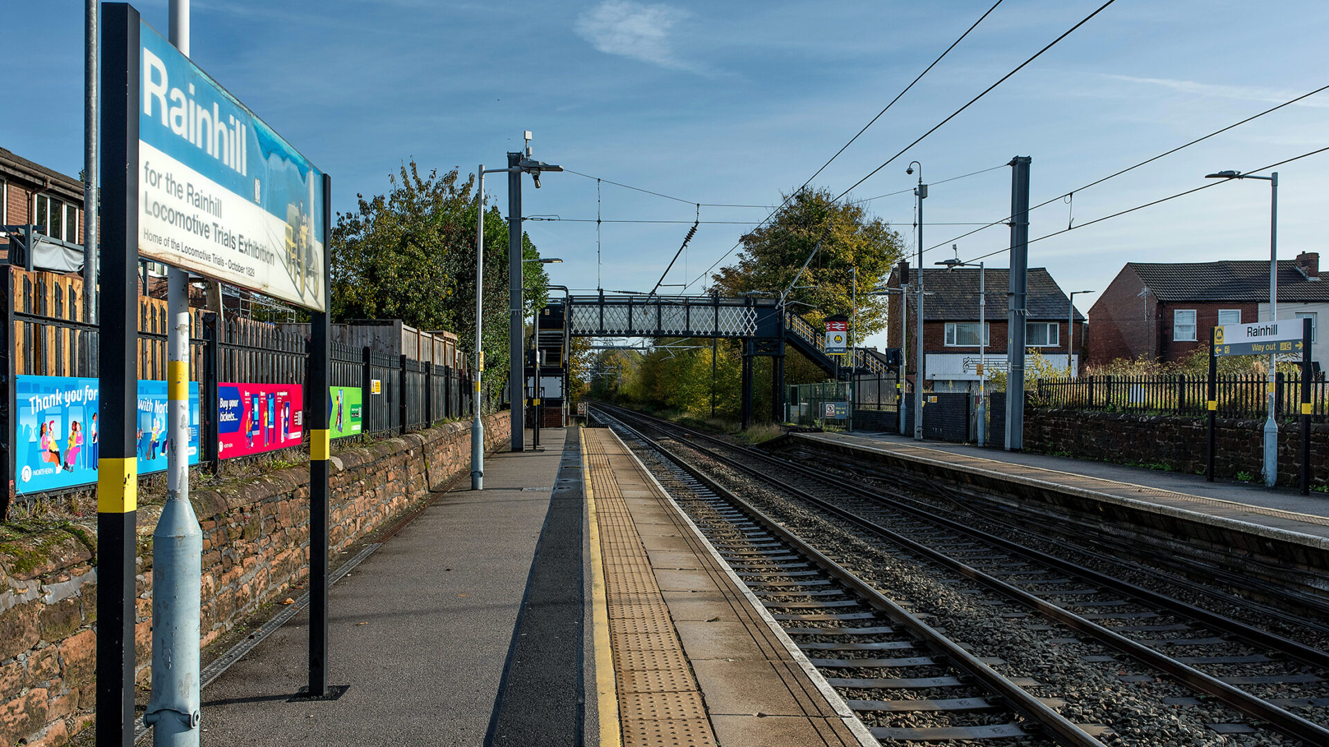 Rainhill station with signage marking the site of the Rainhill Locomotive Trials.