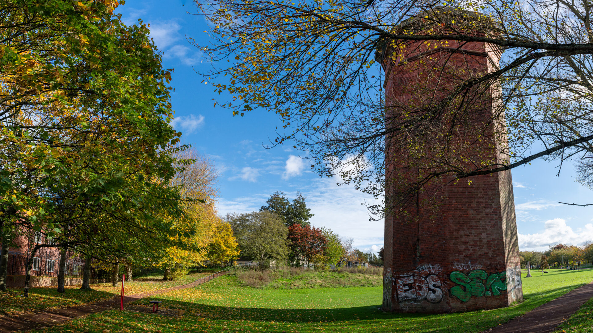 Brick ventilation tower in a park, marking the site of Crown Street station.