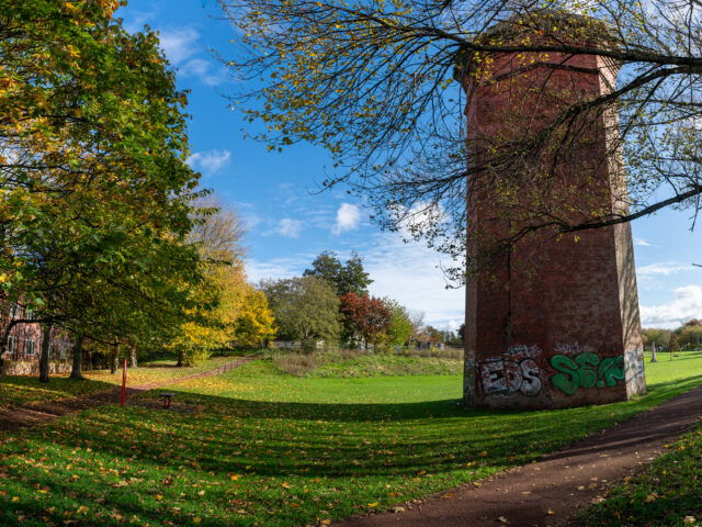 Brick ventilation tower in a park, marking the site of Crown Street station.