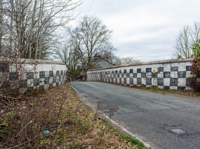 Curving road over bridge with painted brick parapets