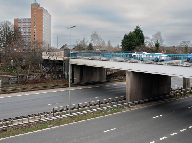 Monks’ Hall Bridge carries a modern road over both a busy dual carriageway and the railway cutting below.