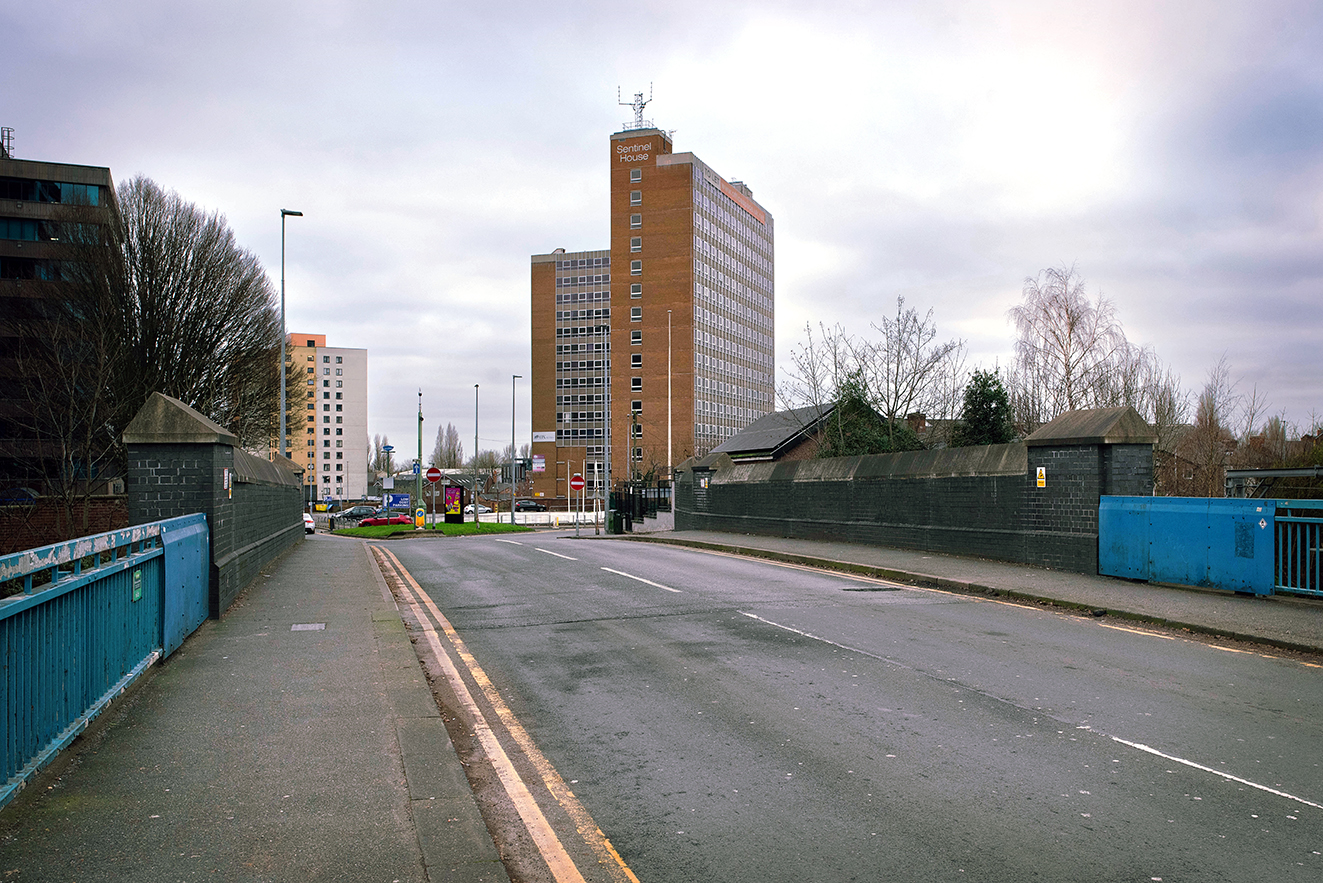 View across the bridge deck with surrounding streets and buildings, showing how the crossing fits into the modern city landscape.