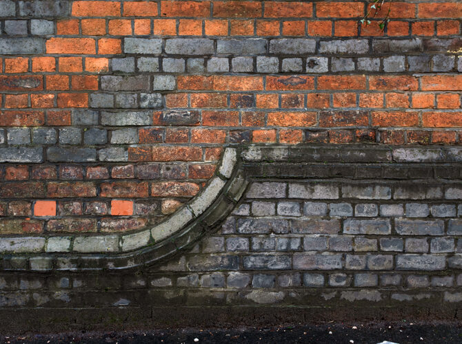 Detail of weathered brickwork showing repairs and decorative stone edging.