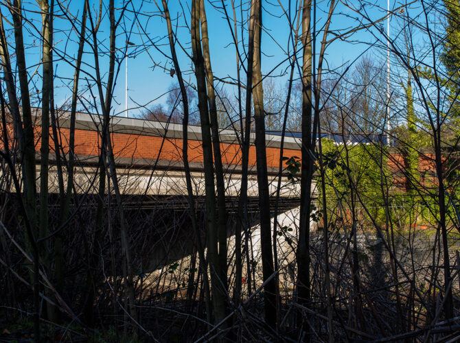 Obscured view of the railway structure within modern surroundings.