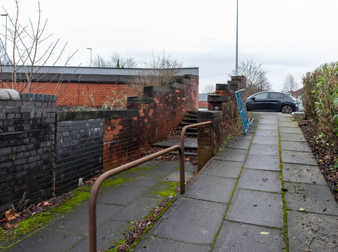 Steps and pedestrian path showing the raised level near the railway crossing.