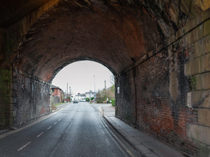 Looking out from inside the arch, the soot-darkened brickwork and daylight beyond capture the bridge’s long working life.