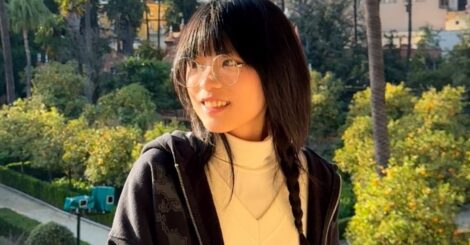 Image of a young Chinese woman with a back drop of blue skies and tress
