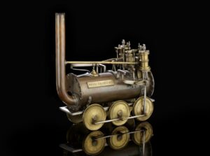 A model of an old locomotive train with a funnel at the front, with gold wheels